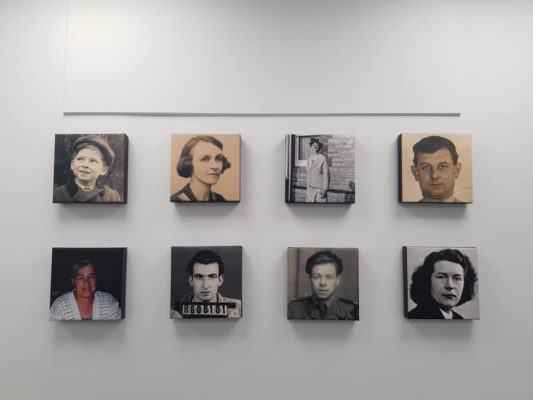 Image canvases of people displayed on a wall