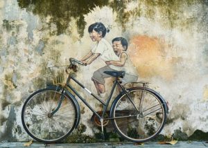 painting of children on a bike