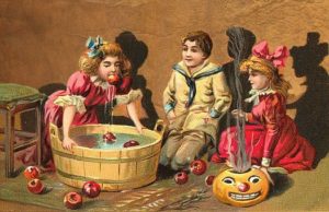 A vintage image of three children apple bobbing