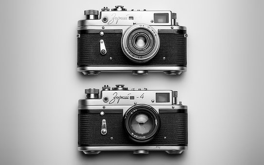 black and white image of two old cameras