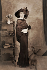 old photograph of a woman in a hat with her dog