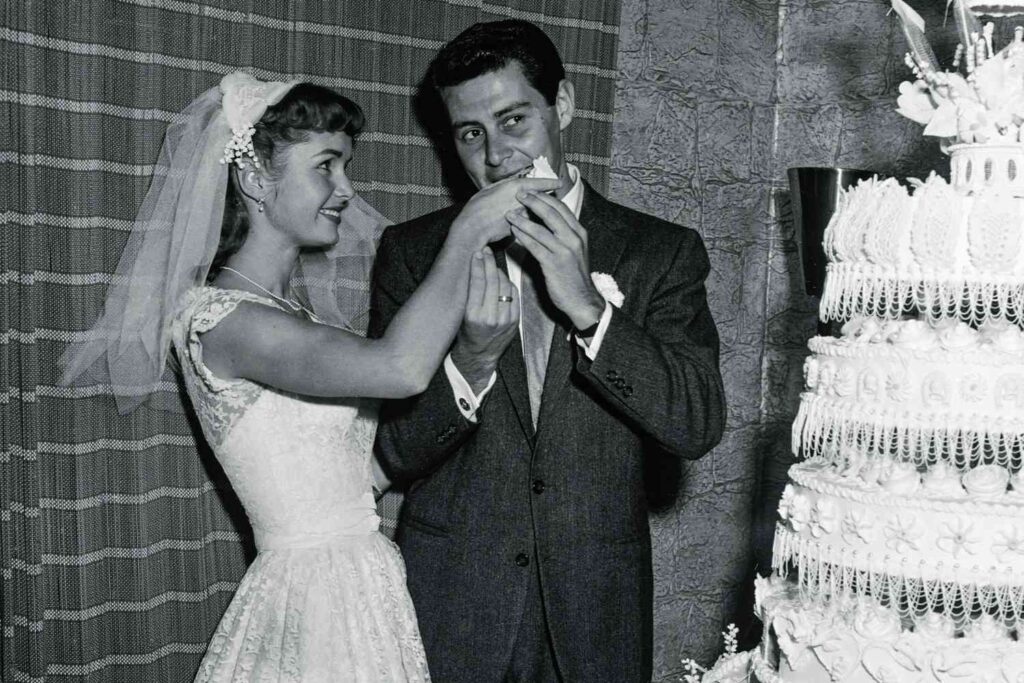 Debbie Reynolds on her wedding day feeding her husband cake