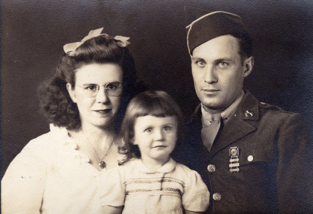 old family photo of mum, dad, and child