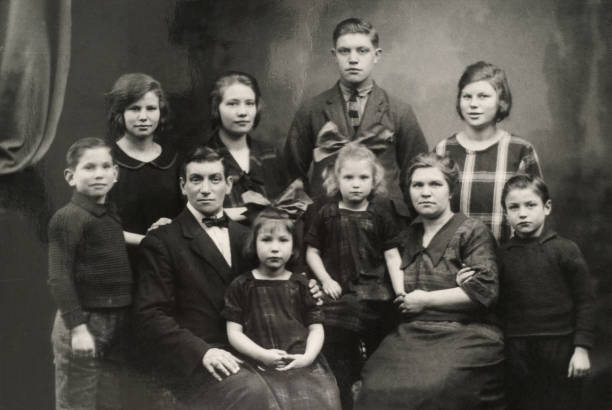 Big family posing for a photograph in the twenties. Two parents, eight children.