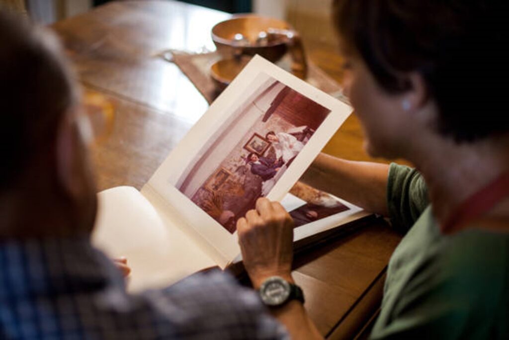 man and a women looking through a photo album