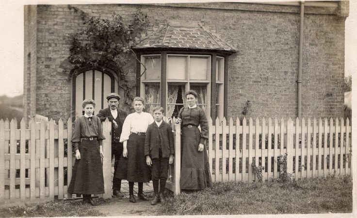 Family stood outside property 1900s